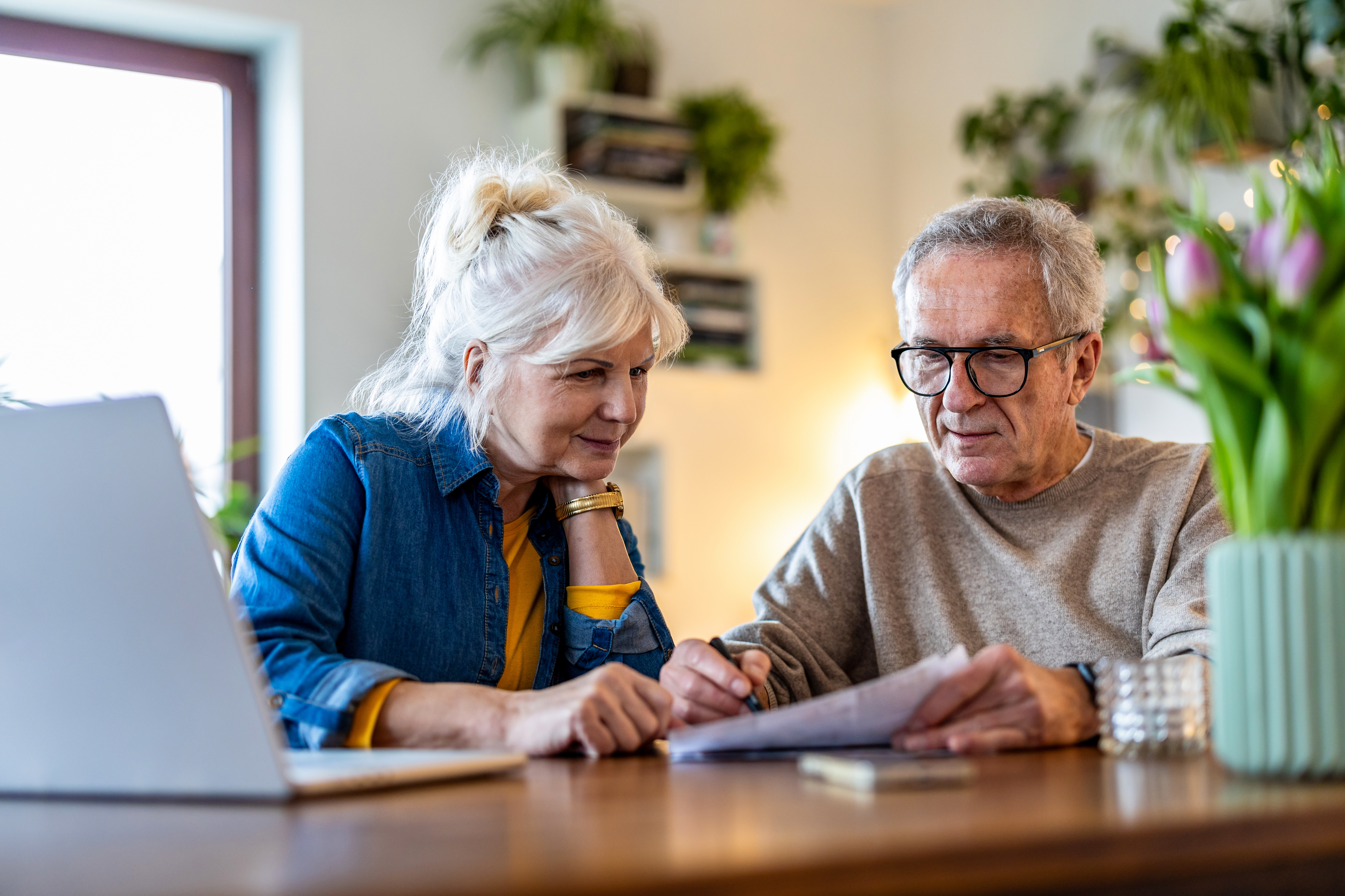 Two older adults going through a checklist on paper.