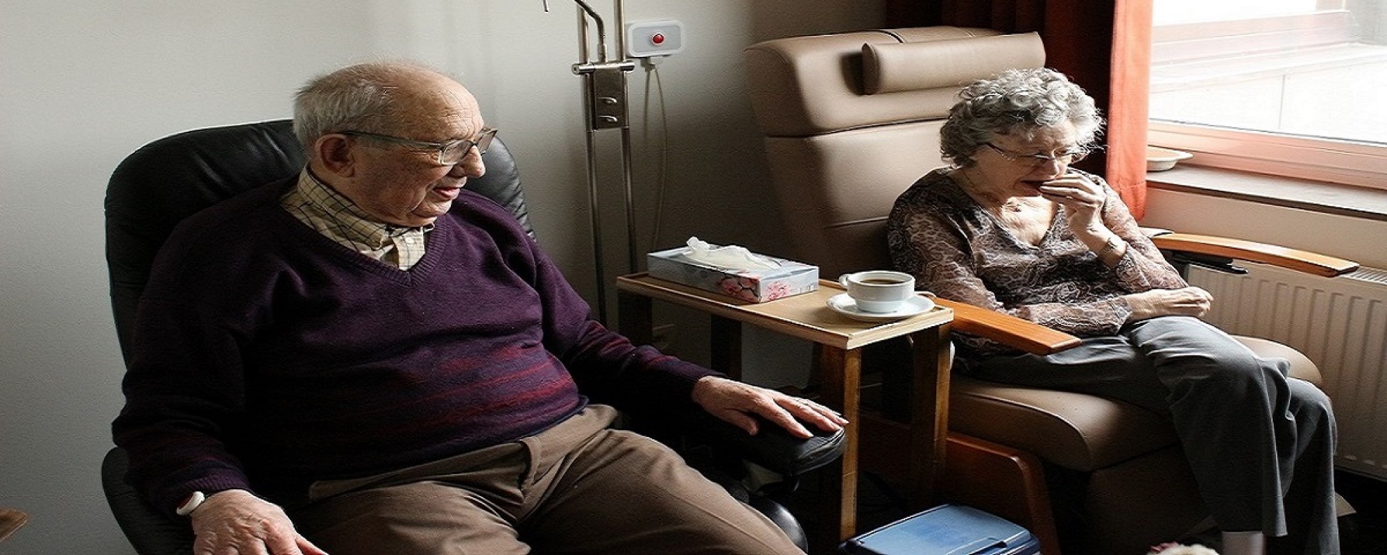 And elderly man and woman sitting on a couch