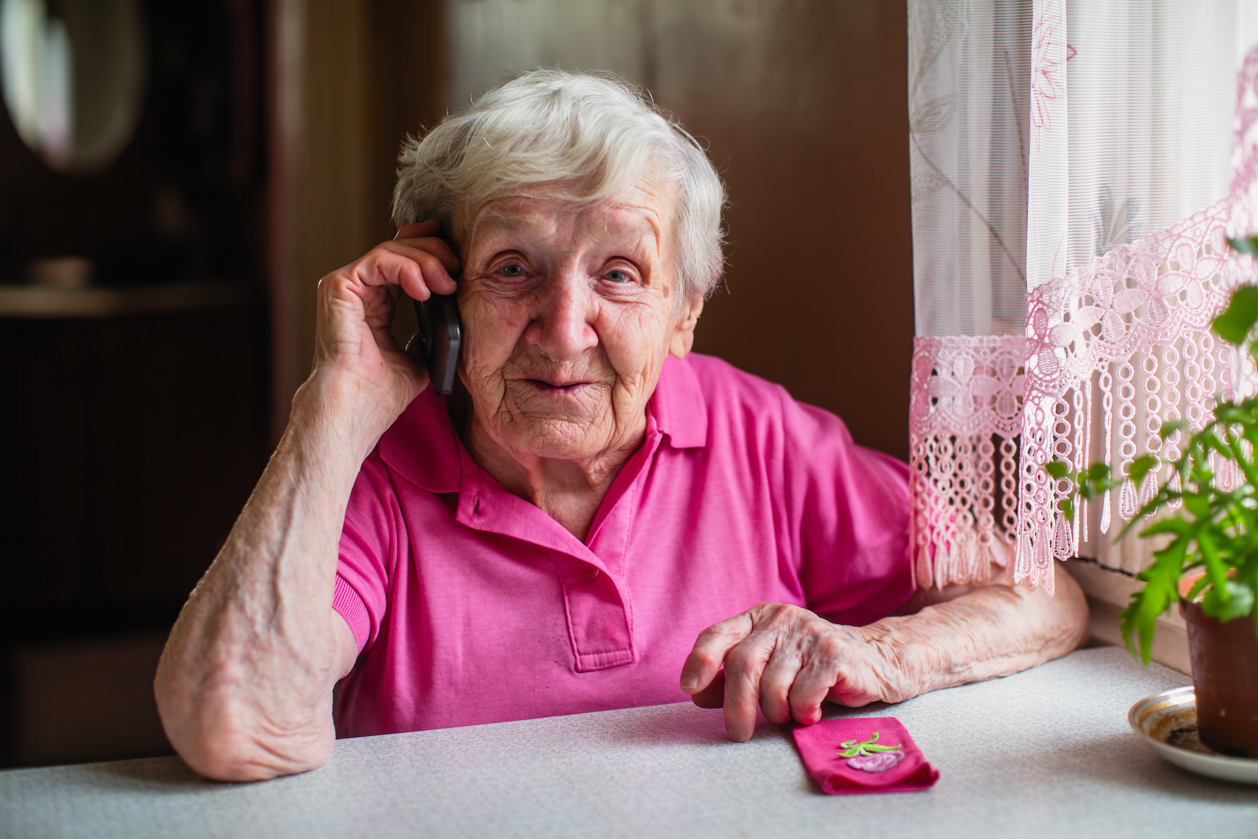 Older adult talking on a smart phone device