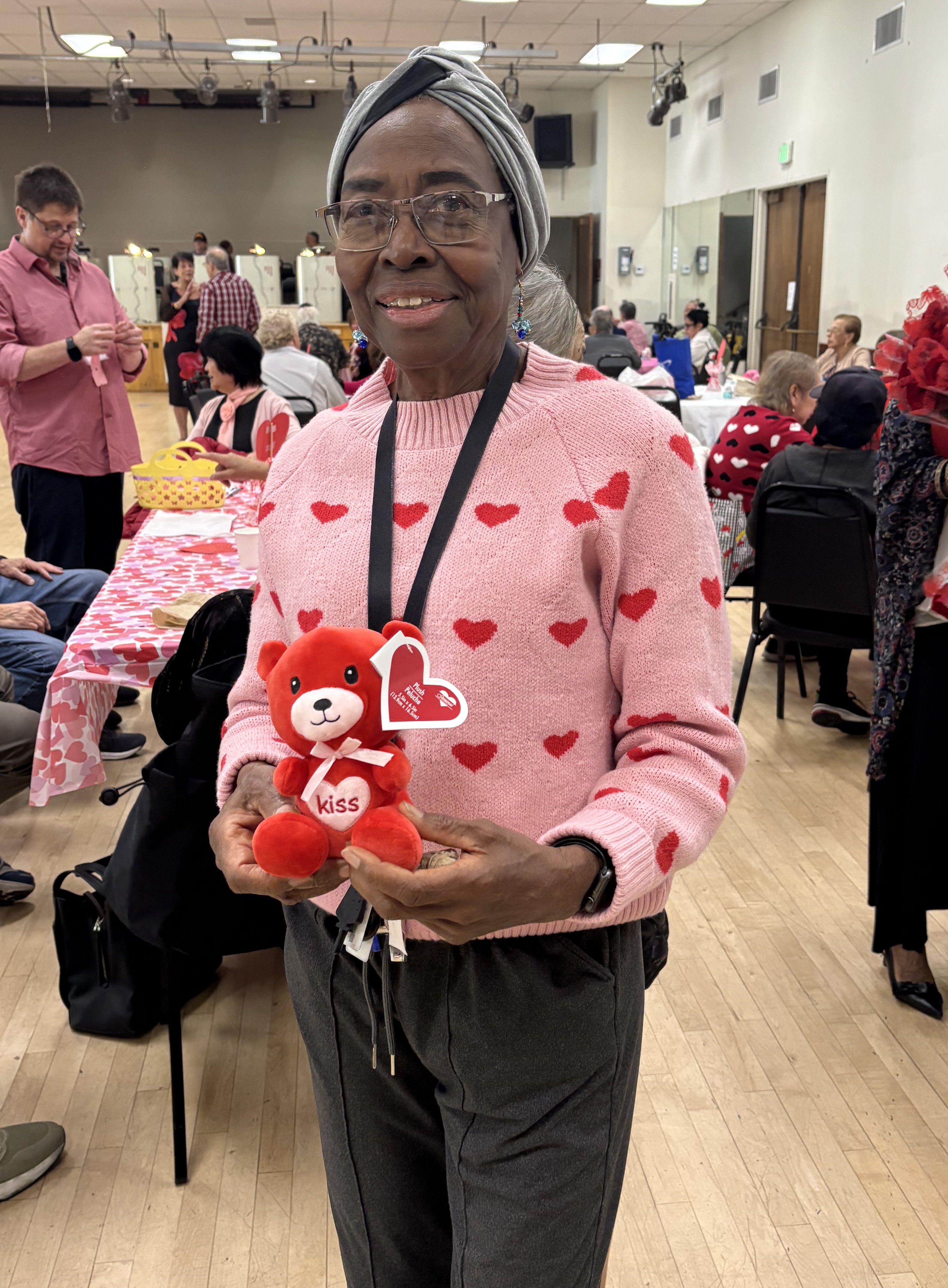 Jerutha Harvey smiling and holding a red teddy bear.