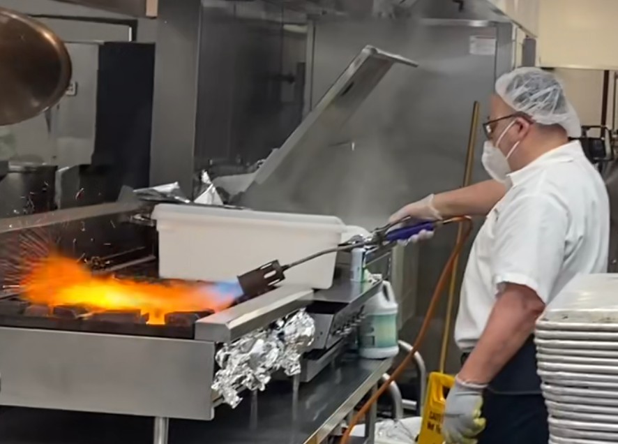 Robert, the mashgiach at the Jona Goldrich Multipurpose Center, overseeing Kosher meal preparation.